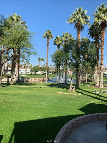 a green field with lots of trees
