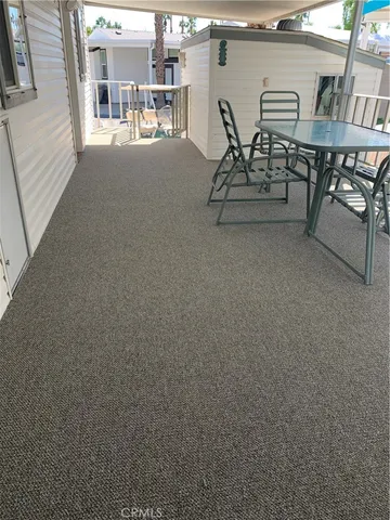 a view of a patio with table and chairs and potted plants
