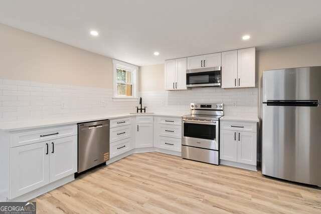 2461 Ridgefield Terrace Decatur, GA 30033 - Photo 14 of 15 a kitchen with white cabinets and stainless steel appliances