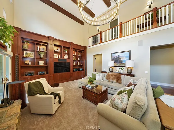 a kitchen with stainless steel appliances granite countertop wooden floor window and chairs
