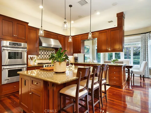 a view of a dining room with furniture wooden floor and chandelier