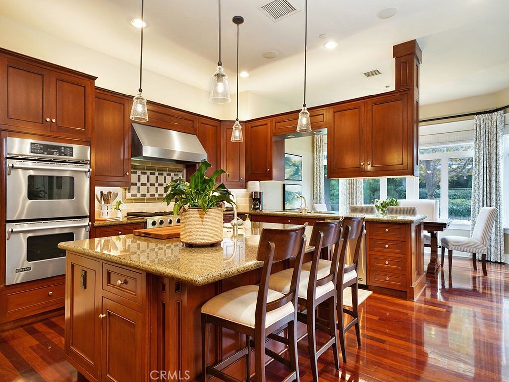 28291 Williams Canyon Road Silverado, CA 92676 - Photo 17 of 74 a kitchen with stainless steel appliances granite countertop wooden floor window and chairs