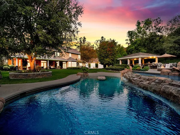 a front view of a house with a garden and pathway