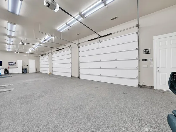 a view of a patio with chairs and a potted plant