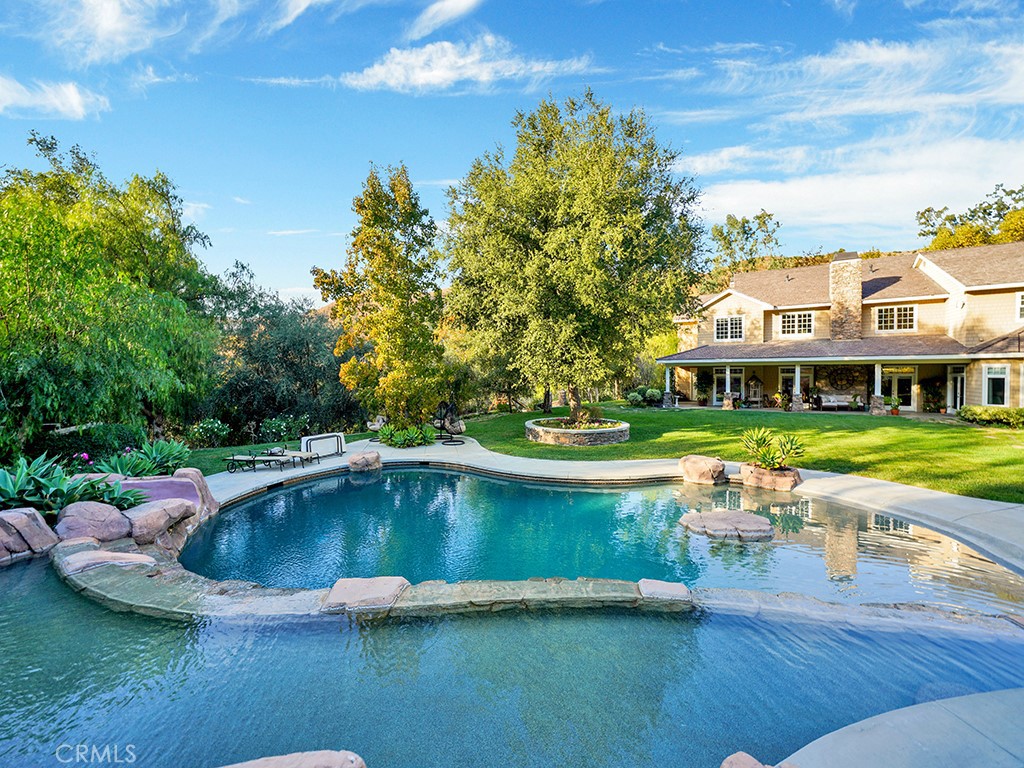 28291 Williams Canyon Road Silverado, CA 92676 - Photo 60 of 74 a view of a swimming pool with lawn chairs under an umbrella