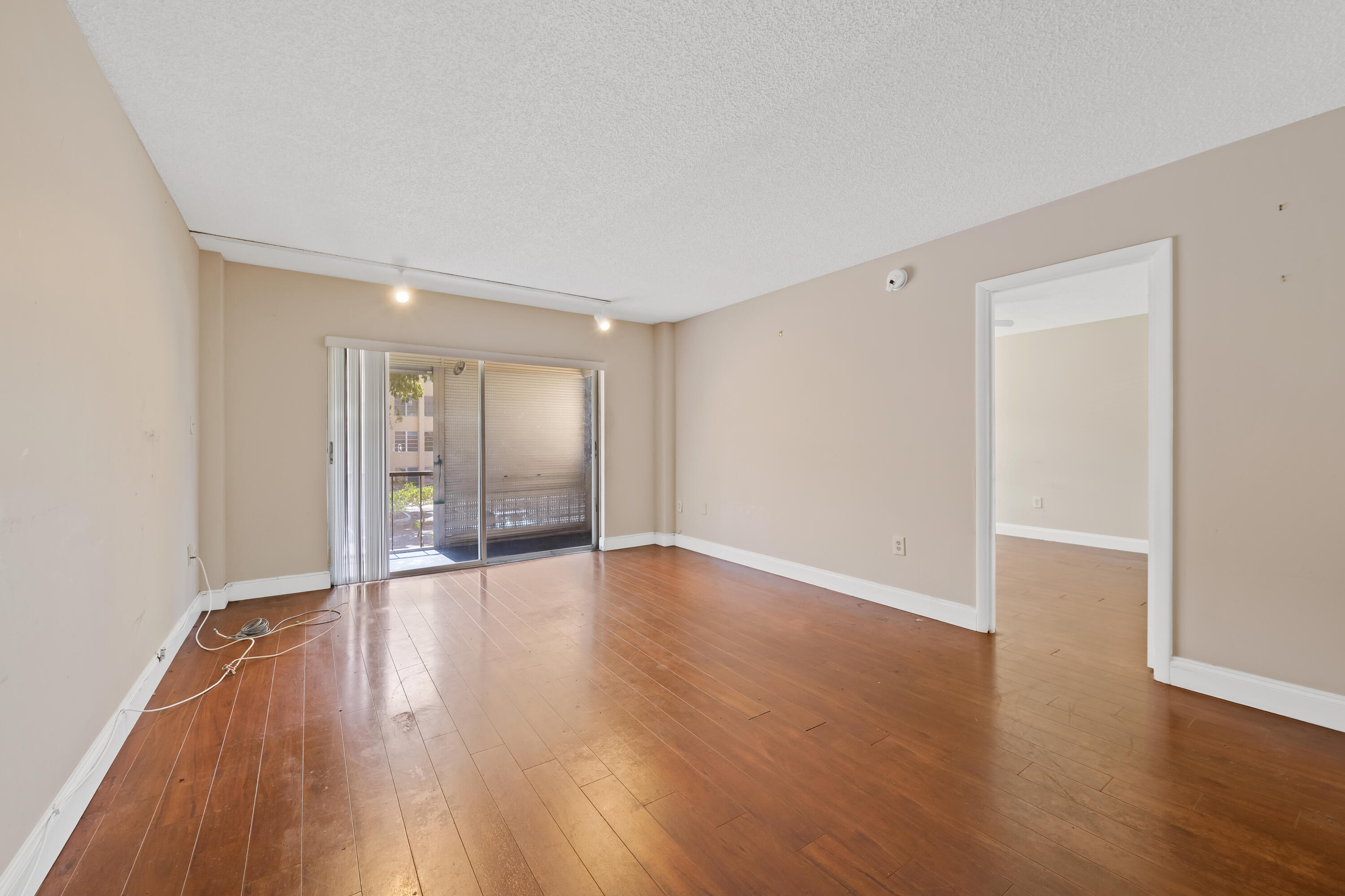 4156 Inverrary Drive, Unit 210 Lauderhill, FL 33319 - Photo 19 of 27 a view of an empty room with wooden floor and a window