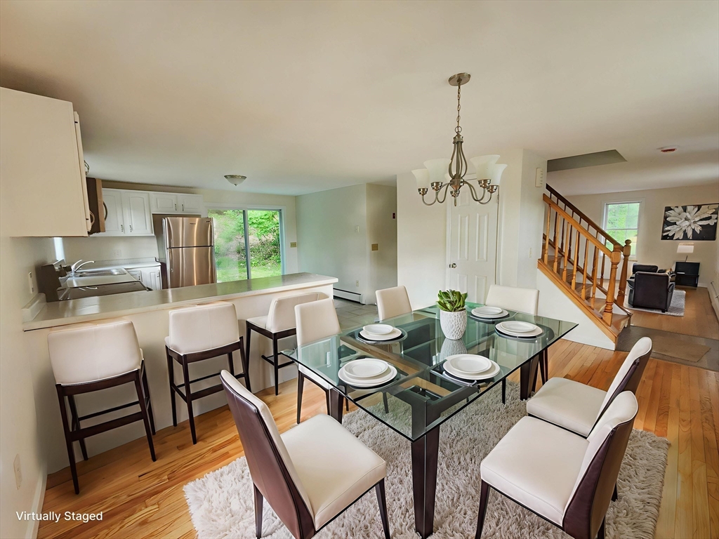 169 Gore Road Webster, MA 01570 - Photo 6 of 15 a dining room with furniture a chandelier and window