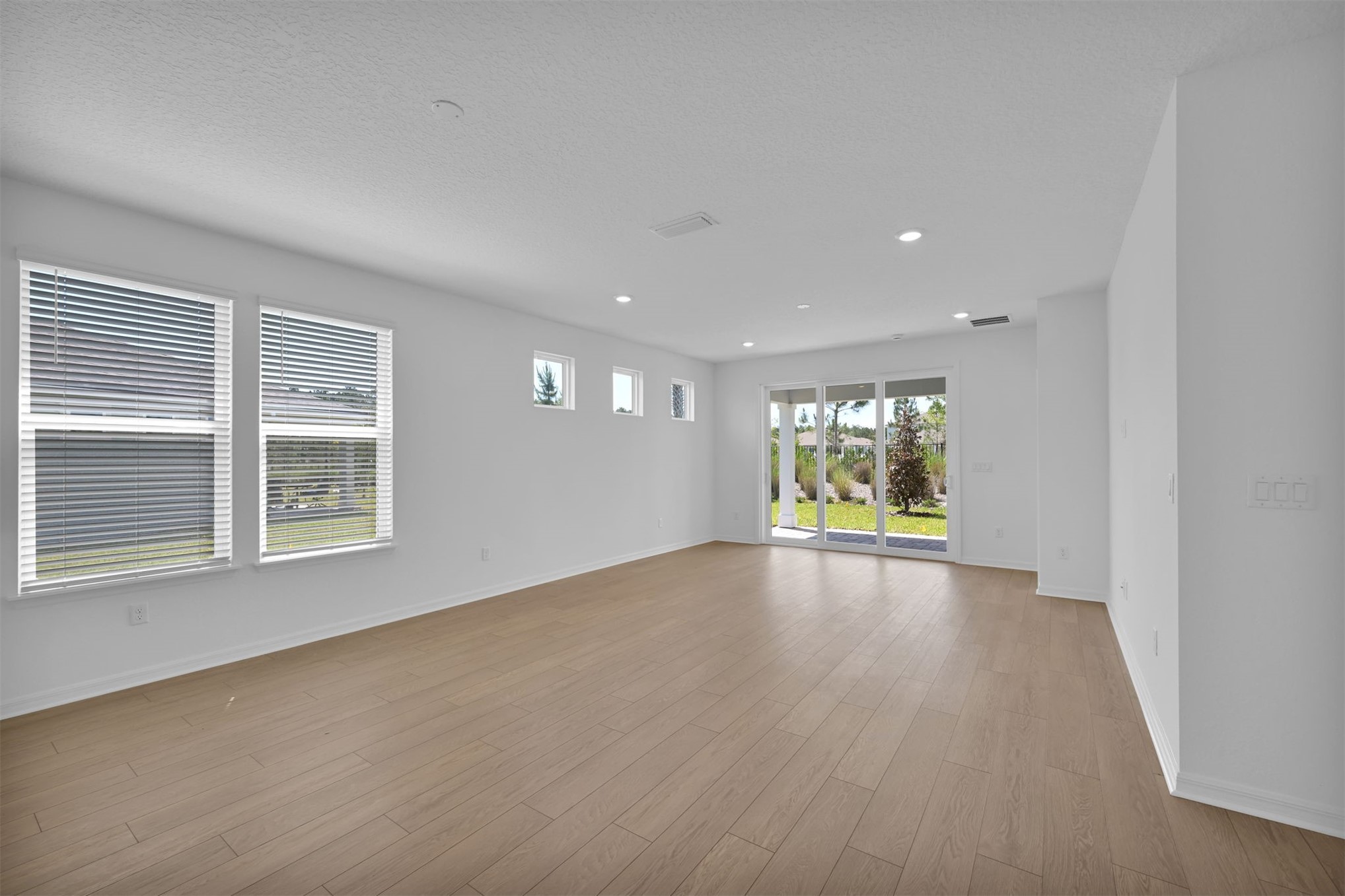 328 Ecliptic Loop Yulee, FL 32097 - Photo 10 of 41 a view of empty room with wooden floor and fan