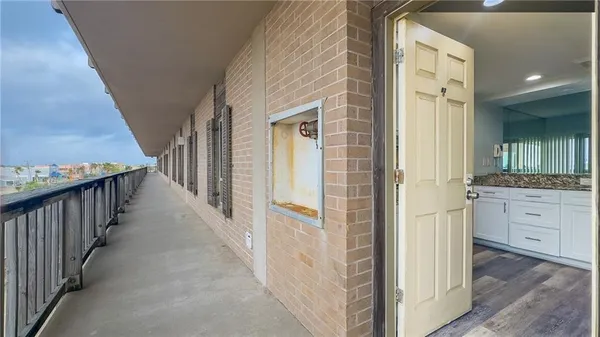 a view of a kitchen with wooden floor and a fireplace