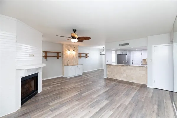 an empty room with wooden floor and fireplace