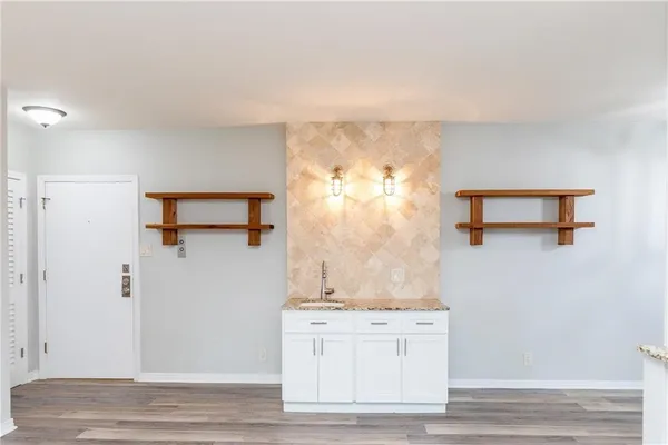 a view of a room with wooden floor chandeliers and a ceiling fan