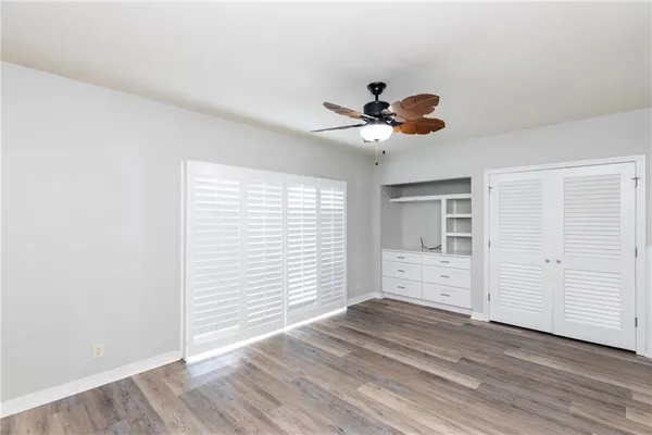 a bathroom with a granite countertop tub sink toilet and shower