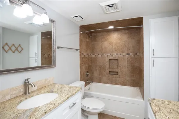 a view of a room with wooden floor and a window