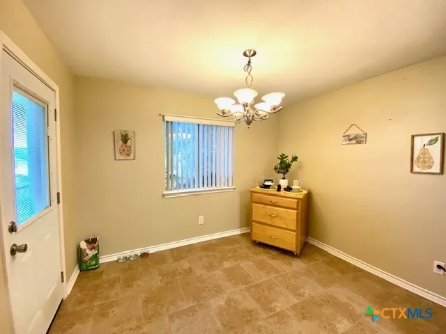 a room with a chandelier and a window