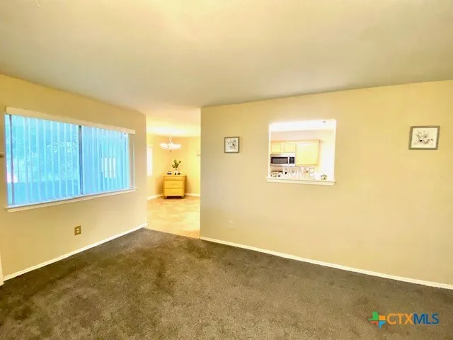 a view of a room with wooden floor and a window