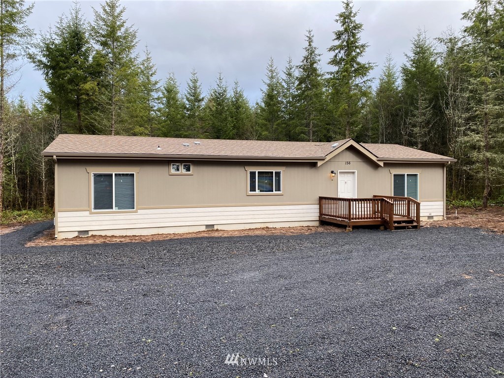 156 Nelson Road Winlock, WA 98596 - Photo 18 of 19 a house with trees in the background