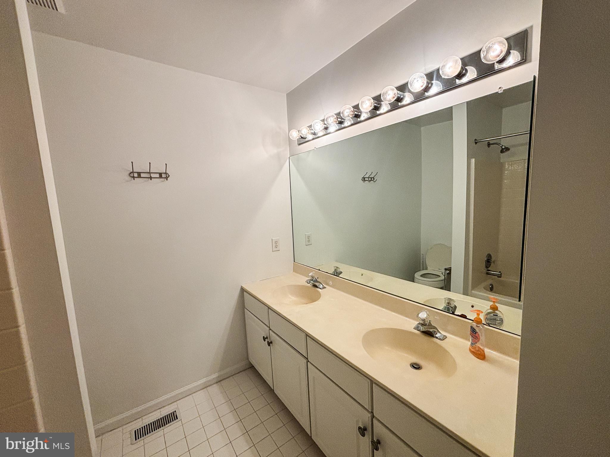 1071 Chanticleer Cherry Hill, NJ 08003 - Photo 14 of 18 a bathroom with a double vanity sink and mirror