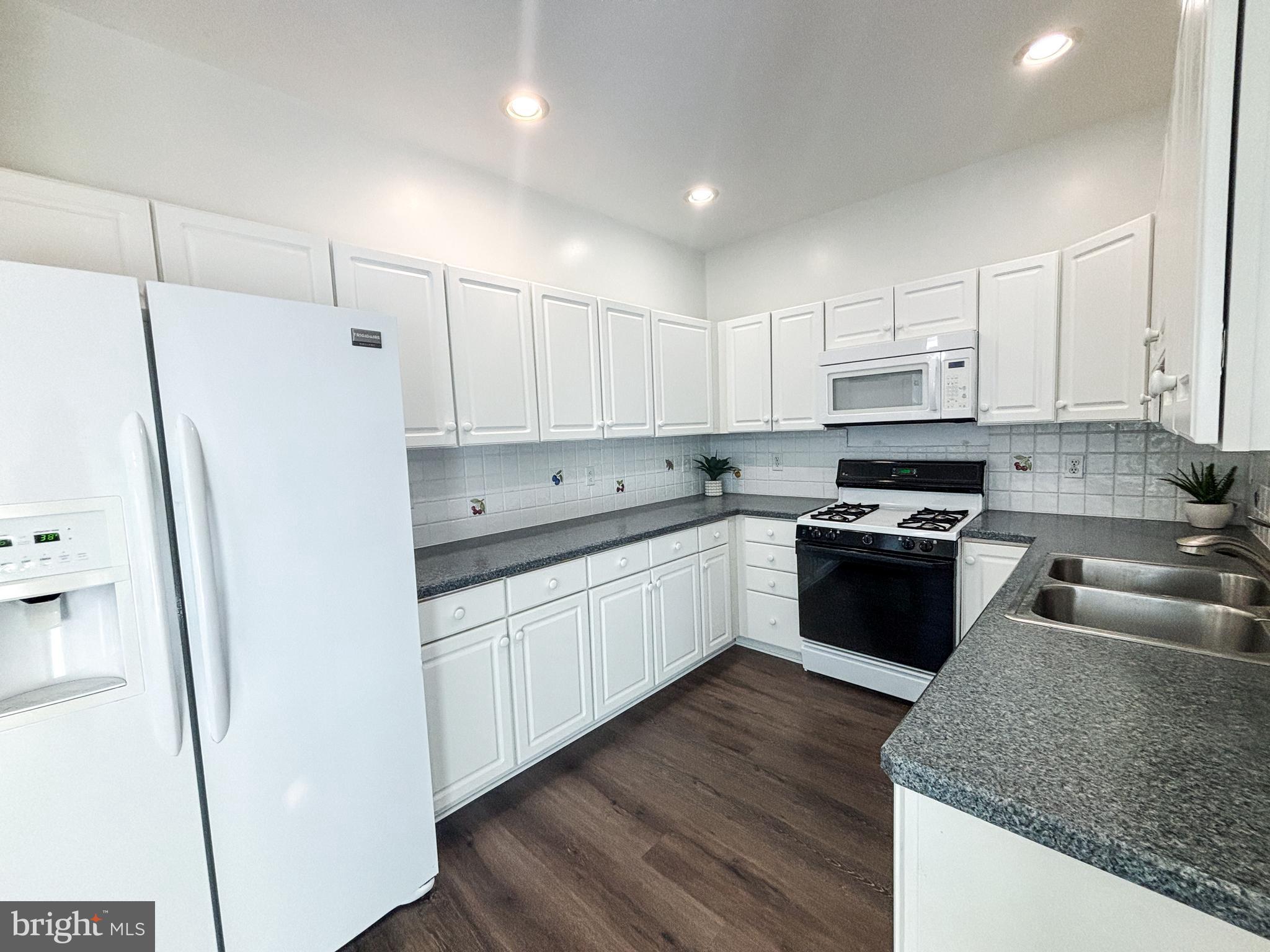 1071 Chanticleer Cherry Hill, NJ 08003 - Photo 4 of 18 a kitchen with stainless steel appliances granite countertop a refrigerator sink and cabinets