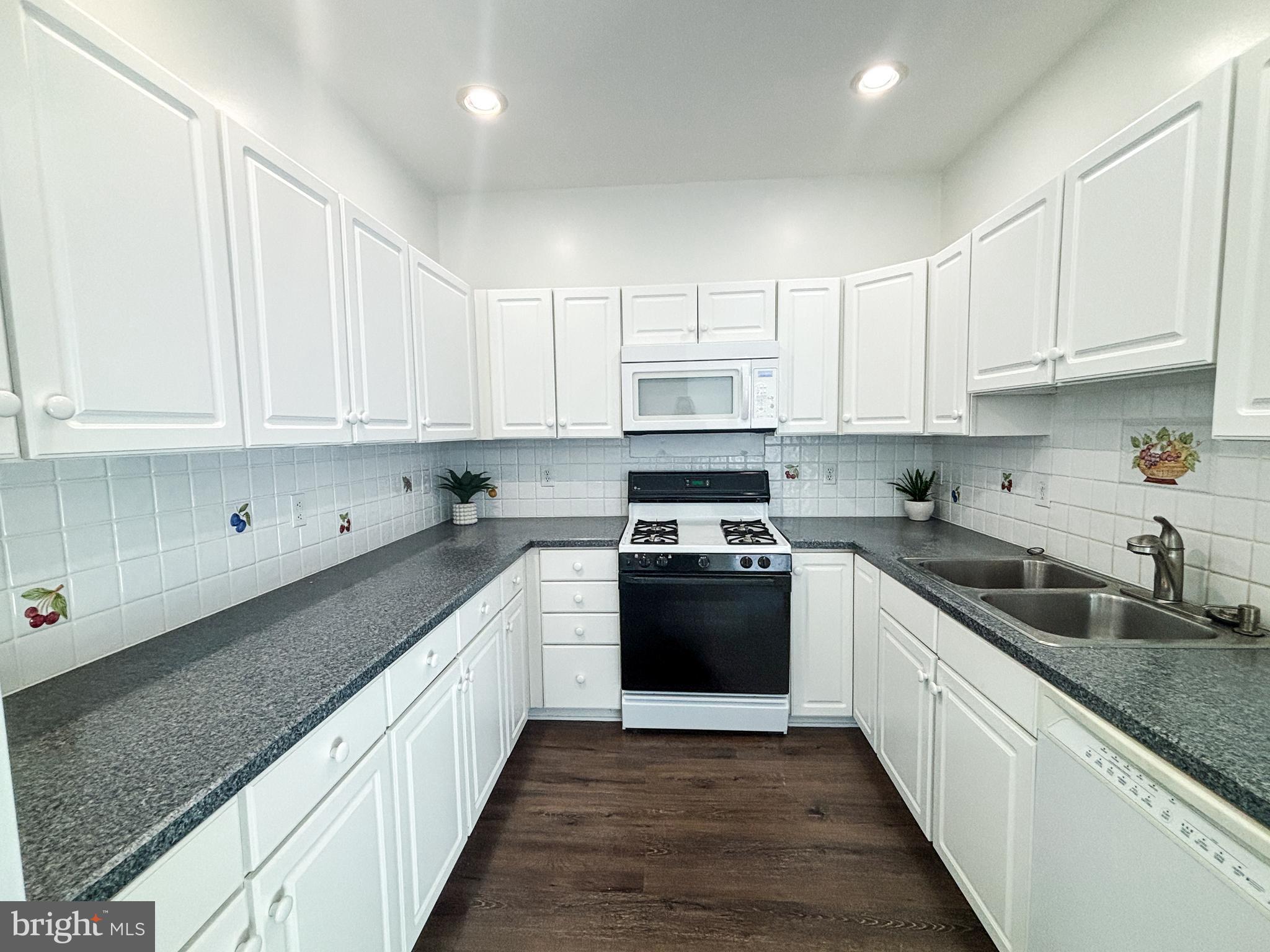 1071 Chanticleer Cherry Hill, NJ 08003 - Photo 5 of 18 a kitchen with stainless steel appliances granite countertop a sink and cabinets