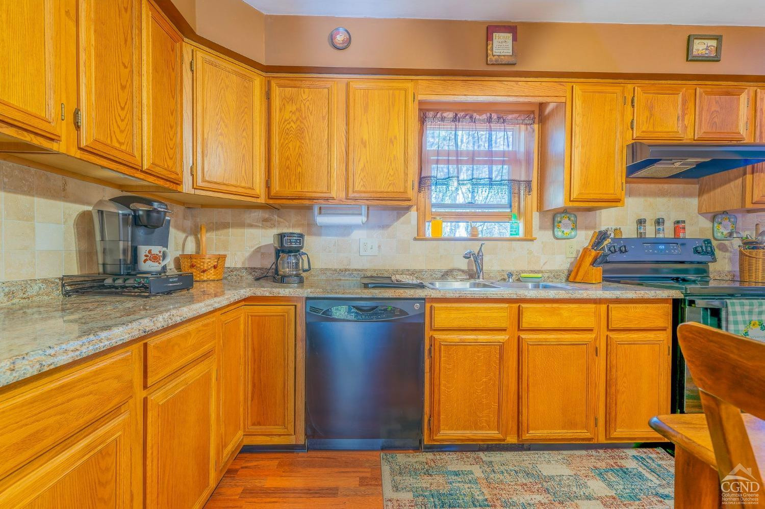1831 Sleepy Hollow Road, Unit VV50 Athens, NY 12015 - Photo 13 of 42 a kitchen with stainless steel appliances granite countertop wooden cabinets a sink and a large window