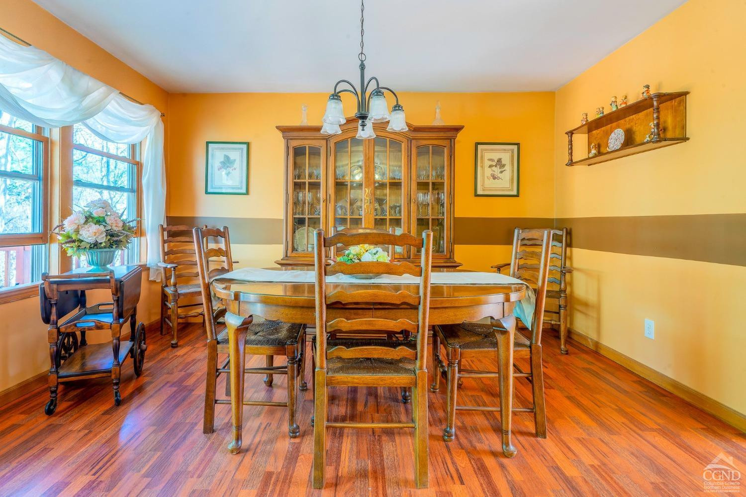 1831 Sleepy Hollow Road, Unit VV50 Athens, NY 12015 - Photo 16 of 42 a dining room with furniture a chandelier and wooden floor