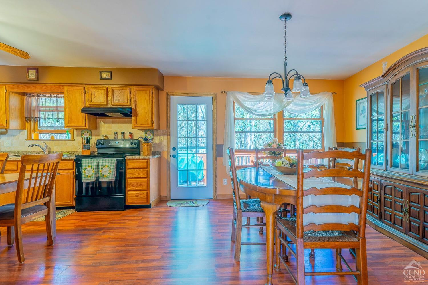 1831 Sleepy Hollow Road, Unit VV50 Athens, NY 12015 - Photo 18 of 42 a dining room with furniture a chandelier and wooden floor
