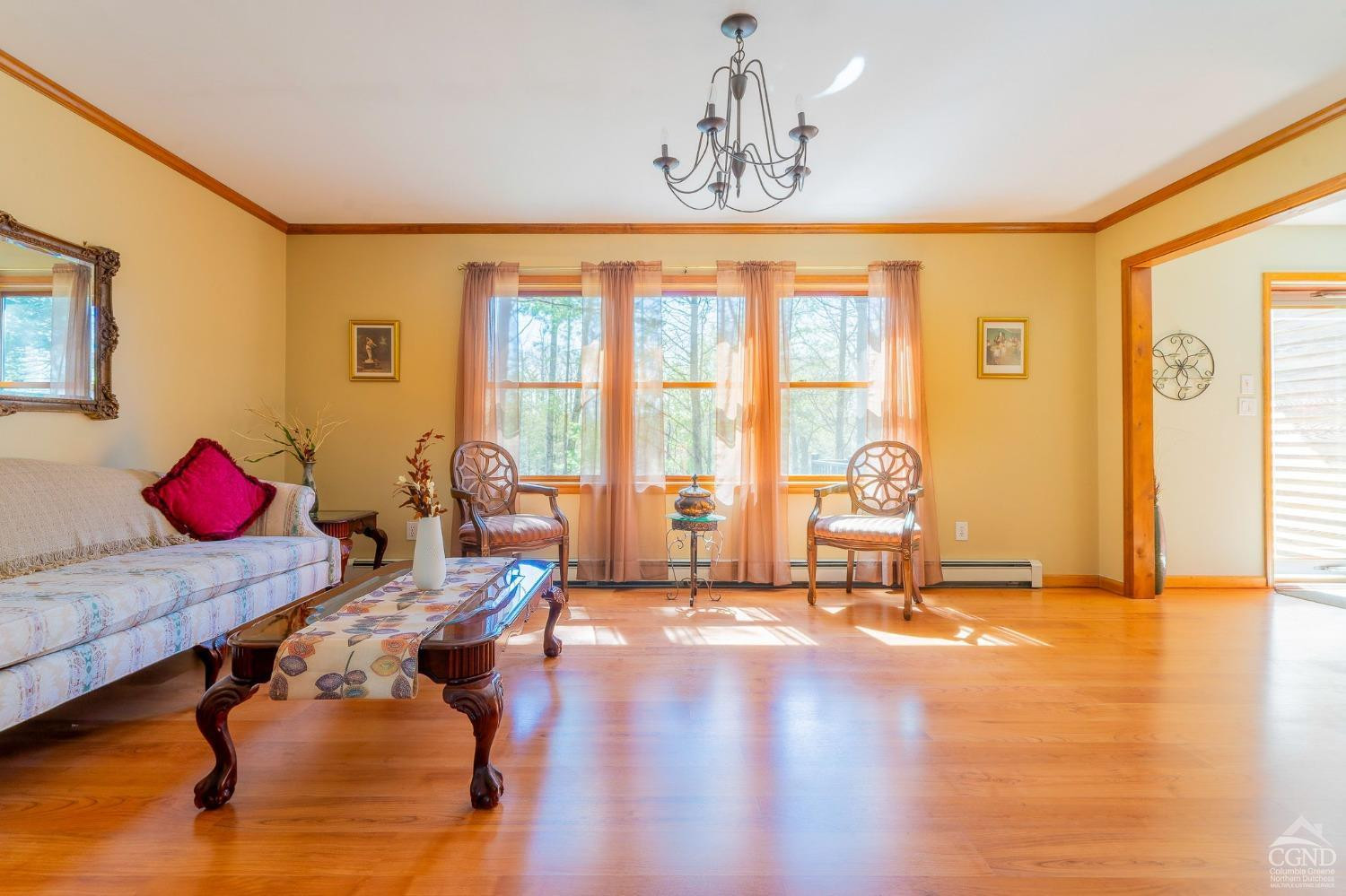 1831 Sleepy Hollow Road, Unit VV50 Athens, NY 12015 - Photo 10 of 42 a view of a livingroom with furniture wooden floor and a floor to ceiling window