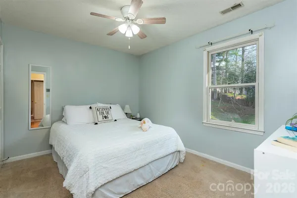 a bedroom with a large bed and a window