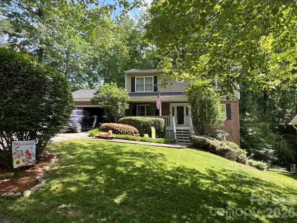 a view of house with outdoor space and garden