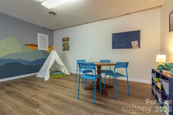 a dining room with furniture and wooden floor