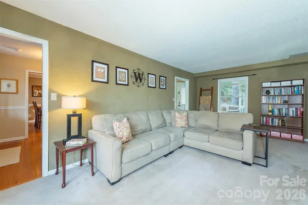 a living room with furniture and a book shelf