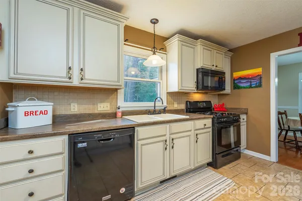 a kitchen with stainless steel appliances granite countertop a sink and a stove
