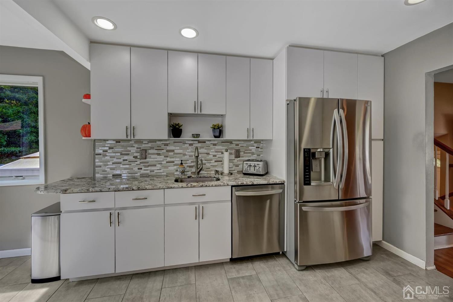 16 Chelsea Road Old Bridge, NJ 08857 - Photo 14 of 33 a kitchen with granite countertop white cabinets and stainless steel appliances