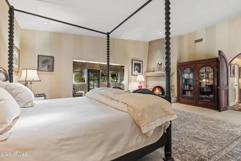 a bed room with a bed and a mirror