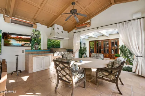 a view of a dining table and chairs in porch