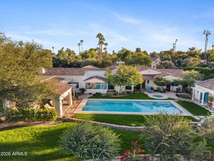 a view of a swimming pool and outdoor seating
