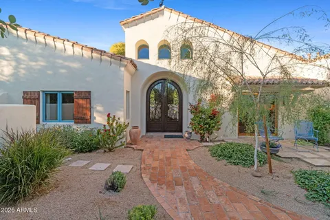 a view of a large white house with a yard