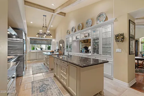 a kitchen with stainless steel appliances granite countertop a sink and a stove top oven