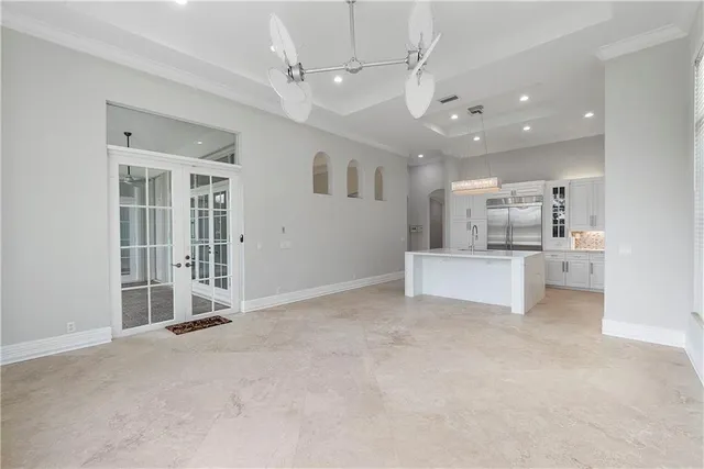 a front view of a house with a garden and trees