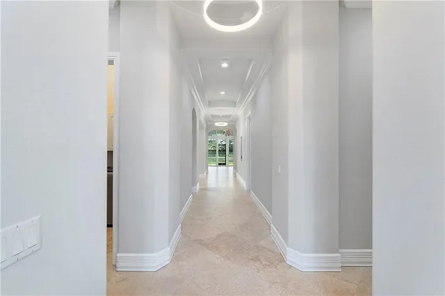 an empty room with wooden floor closet and windows