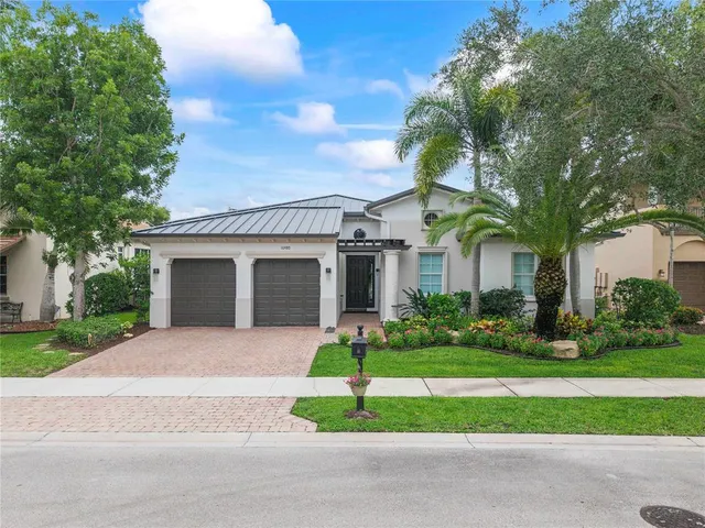 a front view of a house with a garden and garage