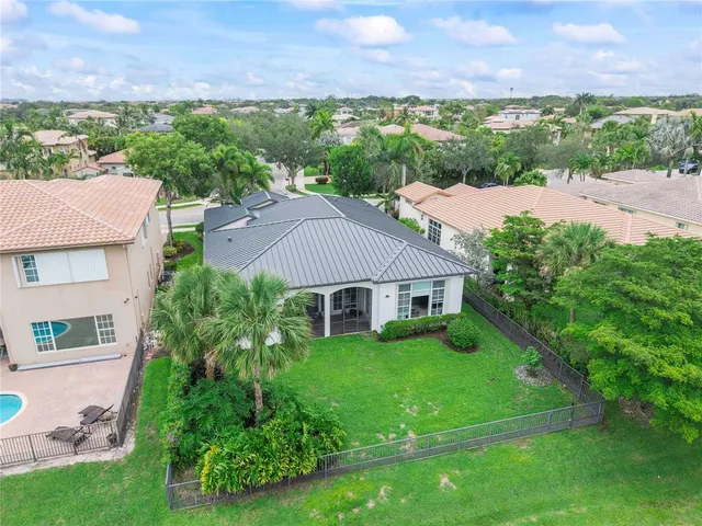 a kitchen with stainless steel appliances kitchen island granite countertop a stove and a sink