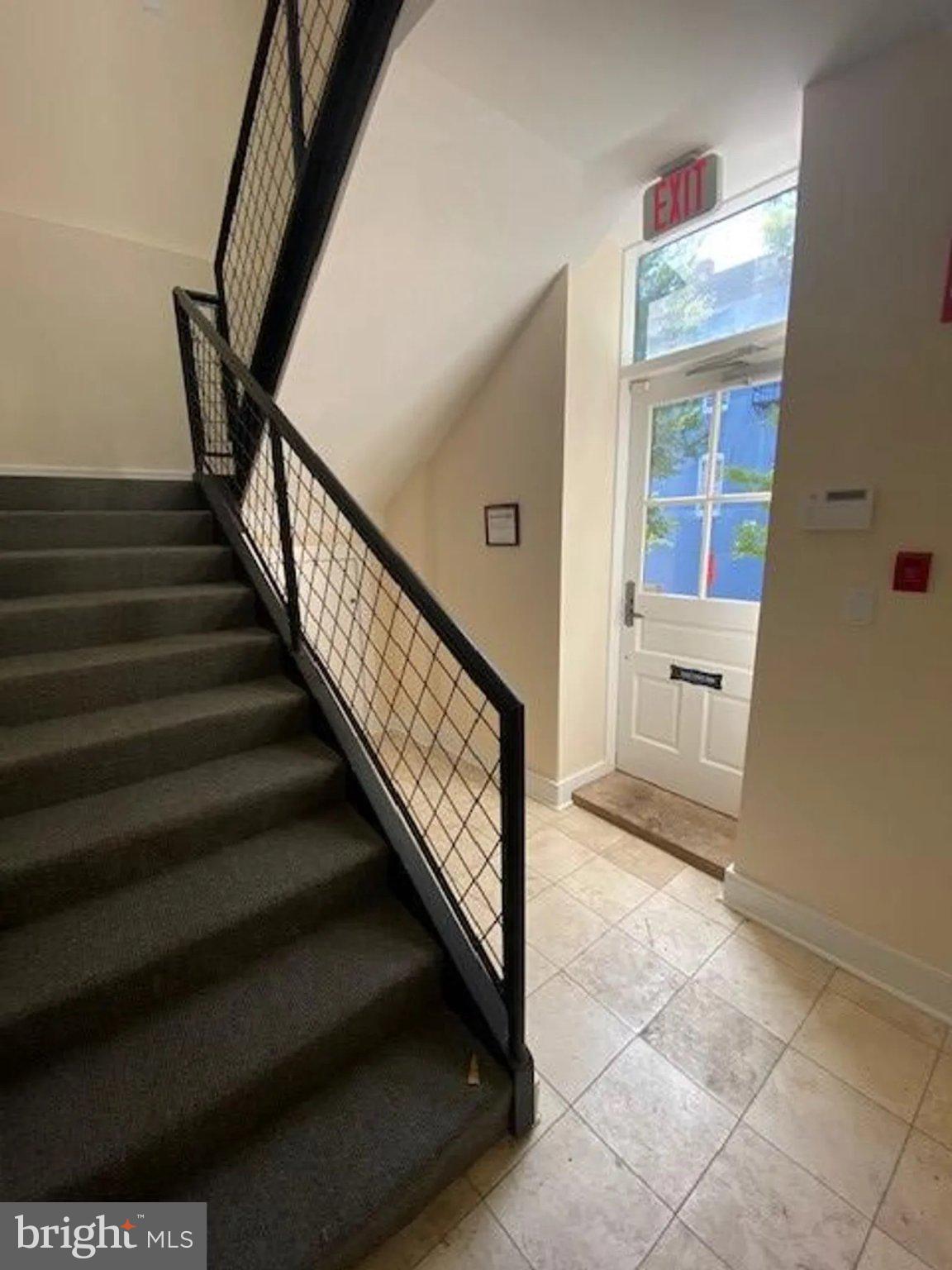 1203 31st Street Northwest, Unit 1 Washington, DC 20007 - Photo 13 of 14 Inviting entryway with modern staircase.