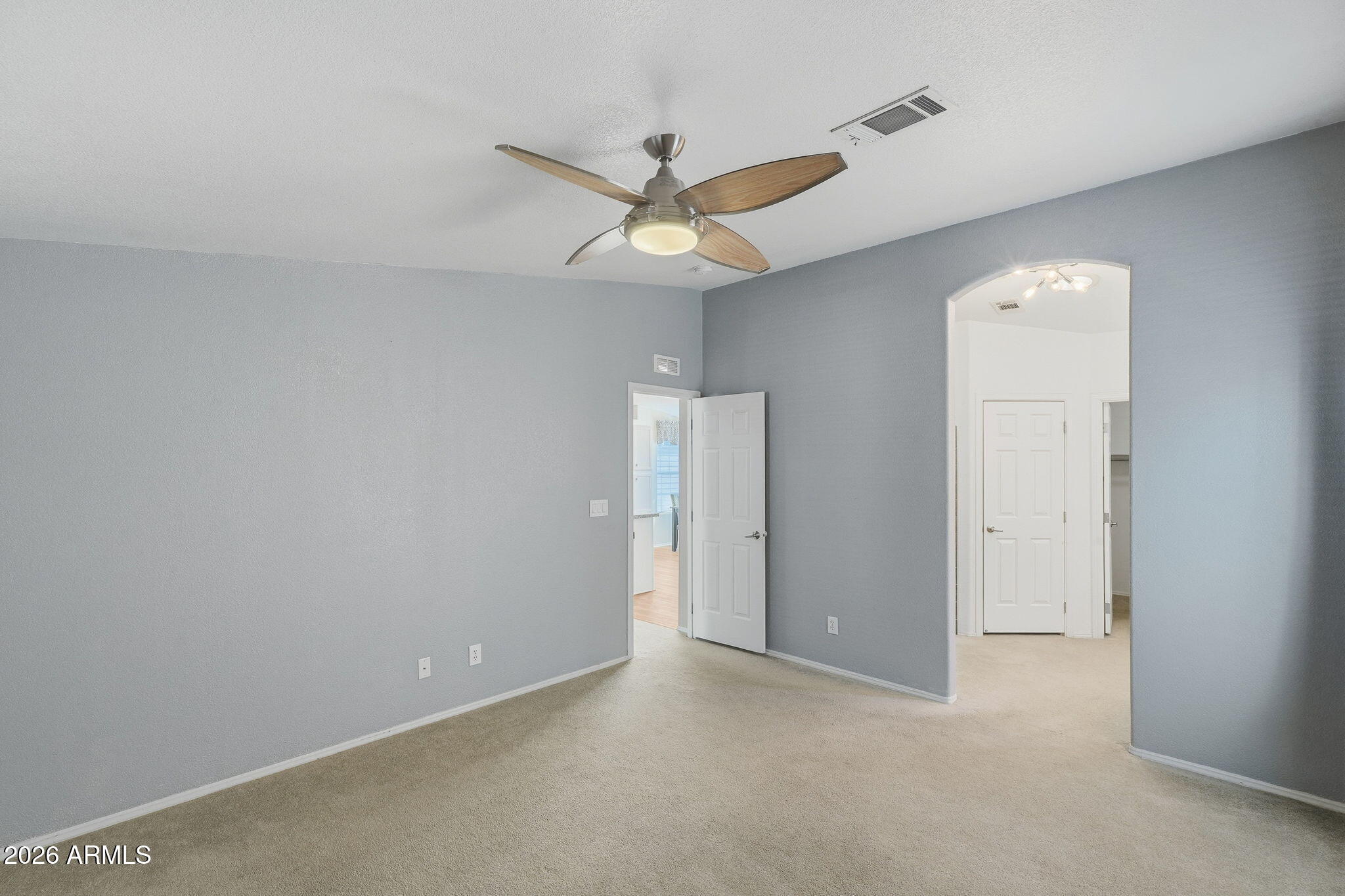 3301 South Goldfield Road, Unit 1015 Apache Junction, AZ 85119 - Photo 16 of 34 an empty room with a fan and a fan