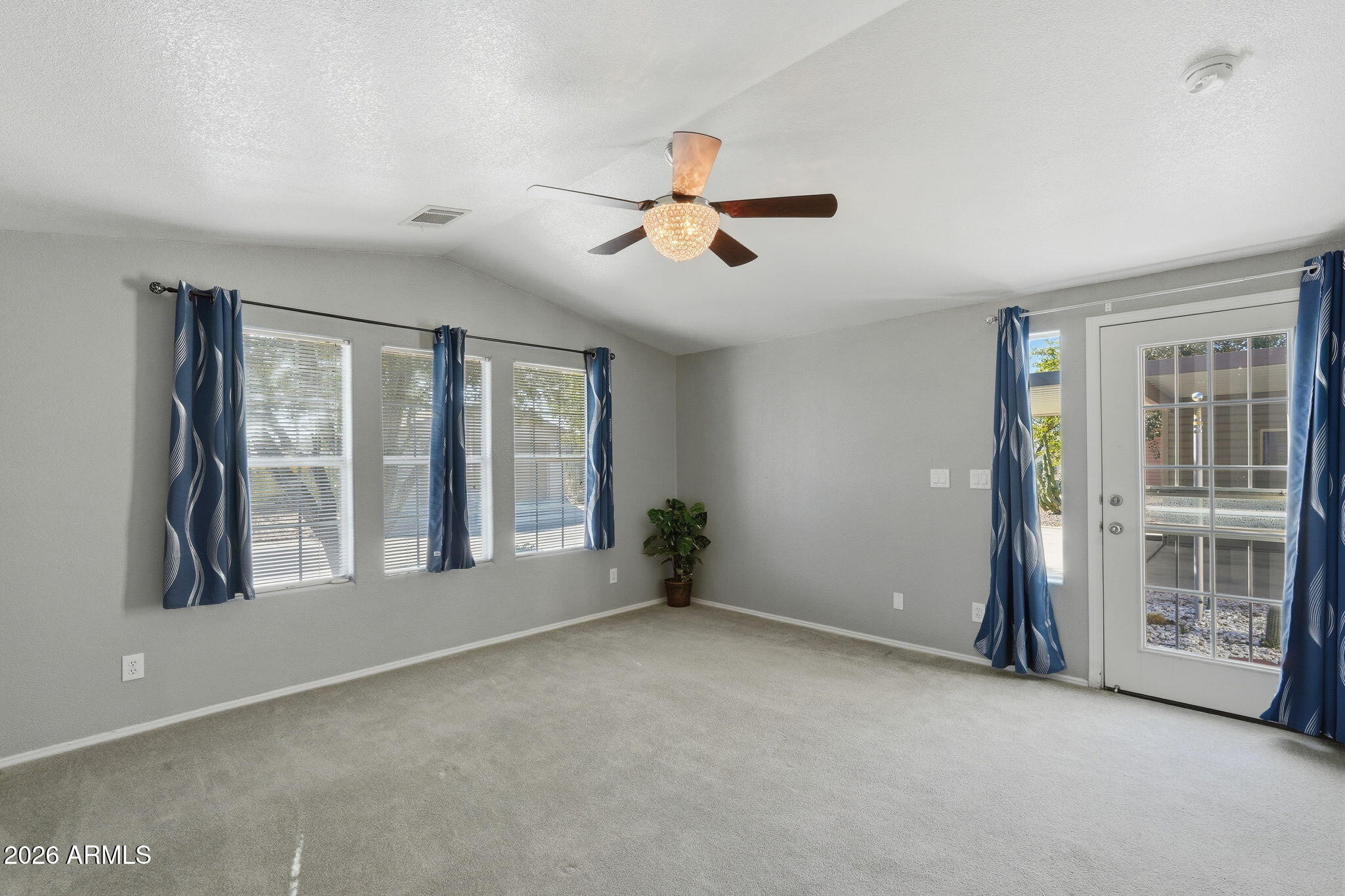 3301 South Goldfield Road, Unit 1015 Apache Junction, AZ 85119 - Photo 21 of 34 a view of an empty room with a window and a kitchen