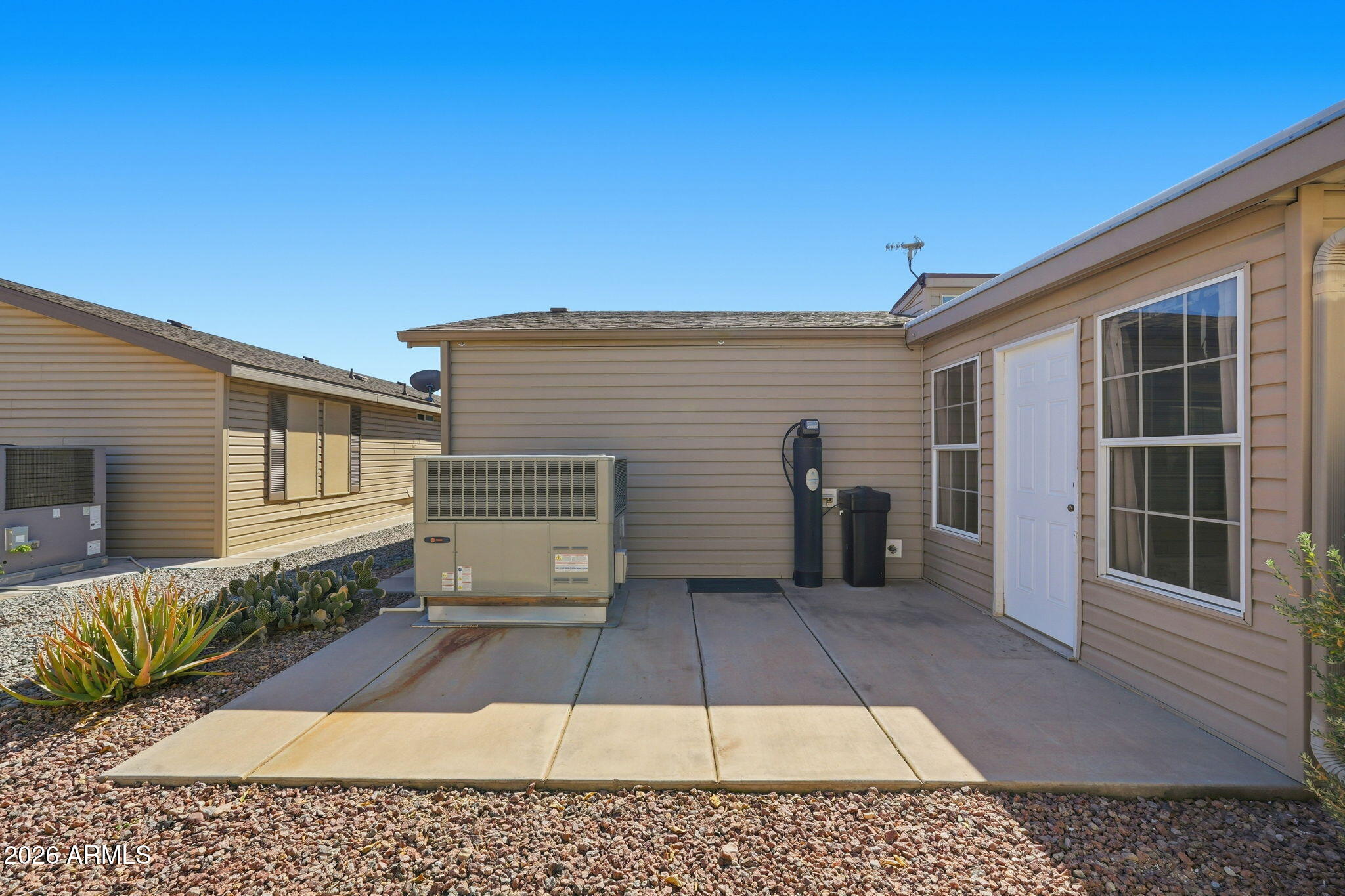 3301 South Goldfield Road, Unit 1015 Apache Junction, AZ 85119 - Photo 33 of 34 a view of a house with a door and a yard