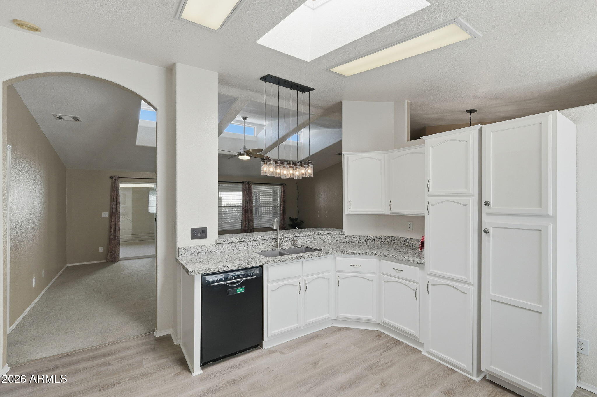 3301 South Goldfield Road, Unit 1015 Apache Junction, AZ 85119 - Photo 6 of 34 a kitchen with cabinets and stainless steel appliances