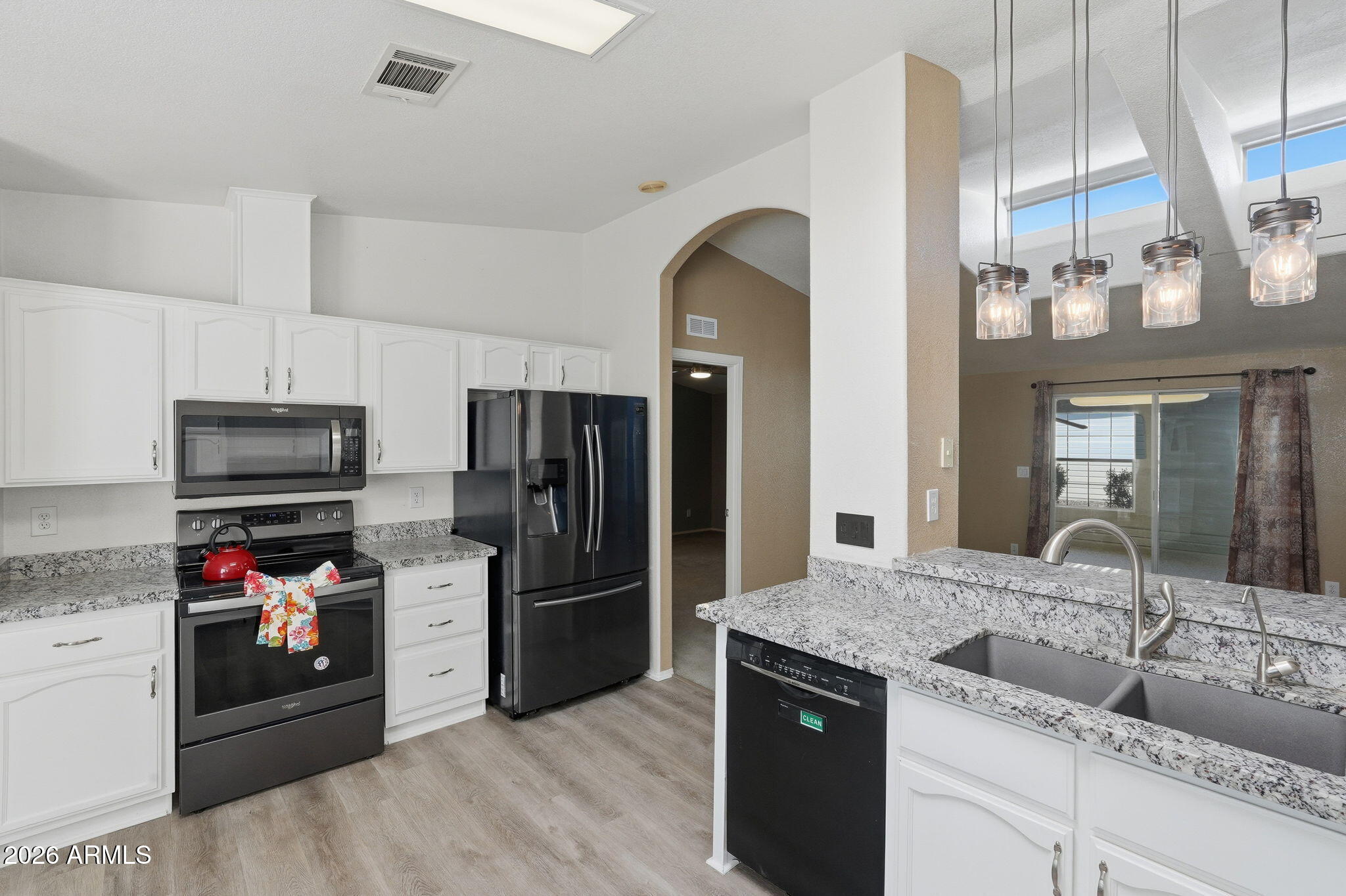 3301 South Goldfield Road, Unit 1015 Apache Junction, AZ 85119 - Photo 7 of 34 a kitchen with a sink stainless steel appliances and cabinets