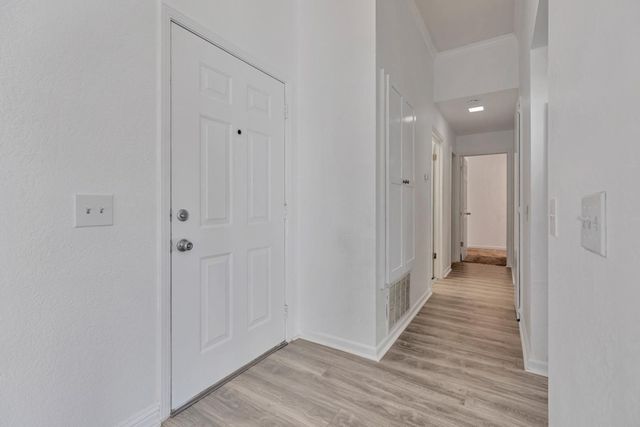 a view of a hallway with wooden floor
