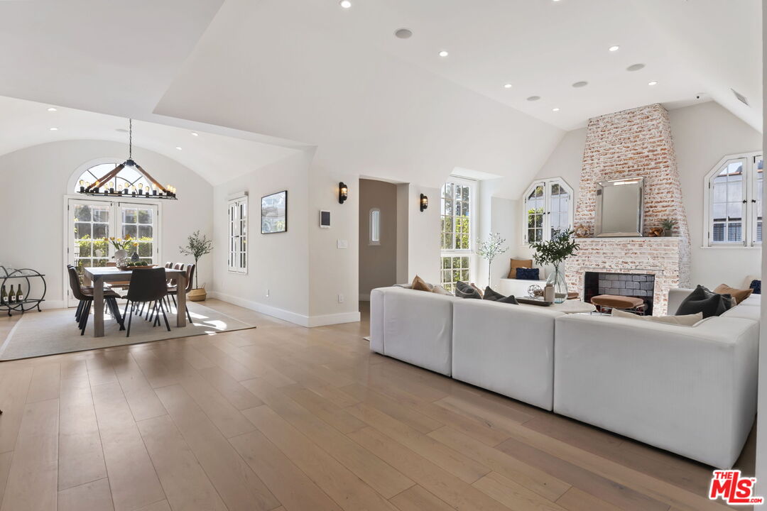 6507 West Olympic Boulevard Los Angeles, CA 90048 - Photo 12 of 50 a living room with furniture a fireplace and a chandelier